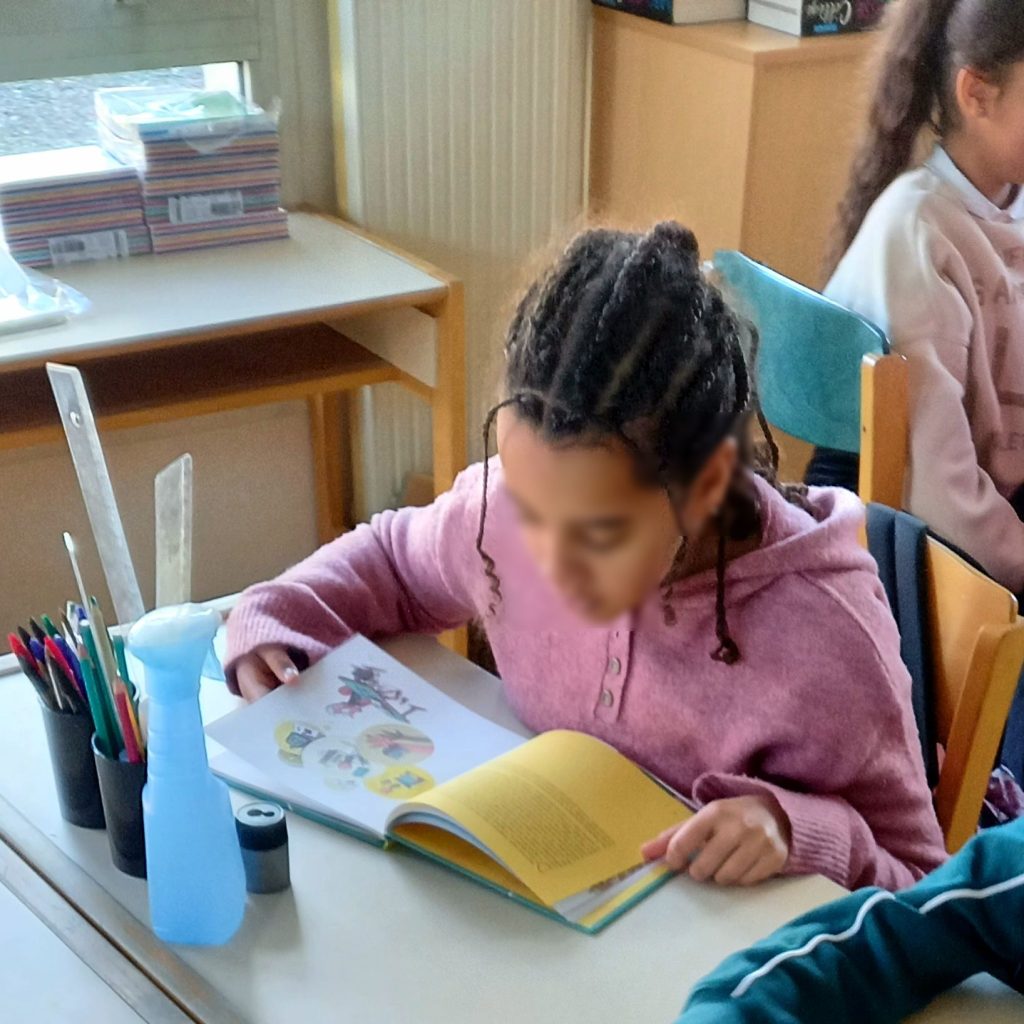Students in a phone-free classroom focusing on a lesson while smartphones stay put away
